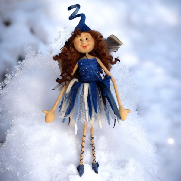 A decorative fairy art doll made from wool and felt.