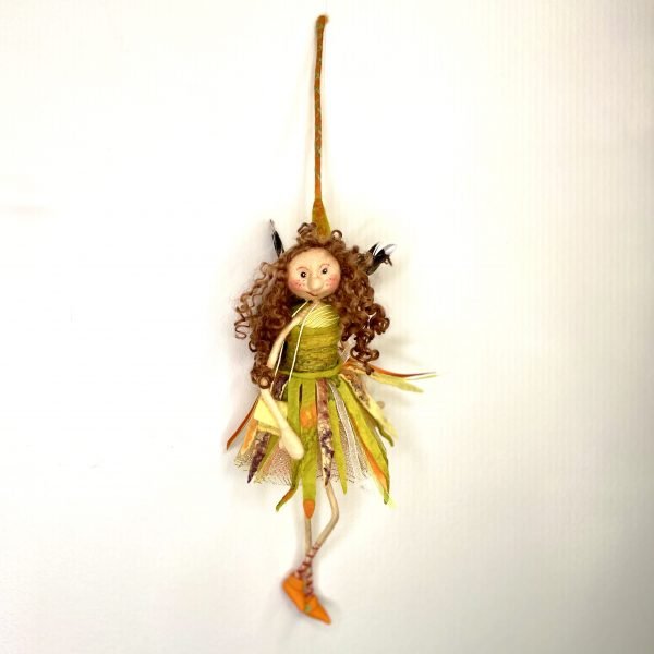 art doll made from green wool with brown hair.